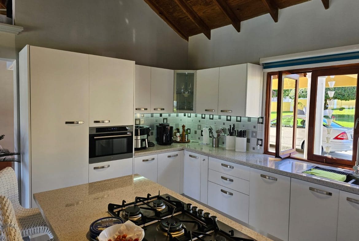 buyDRproperty Modern kitchen in a luxury villa, showcasing countertops and appliances. Ocean Views villa for sale. Sosua Real Estate