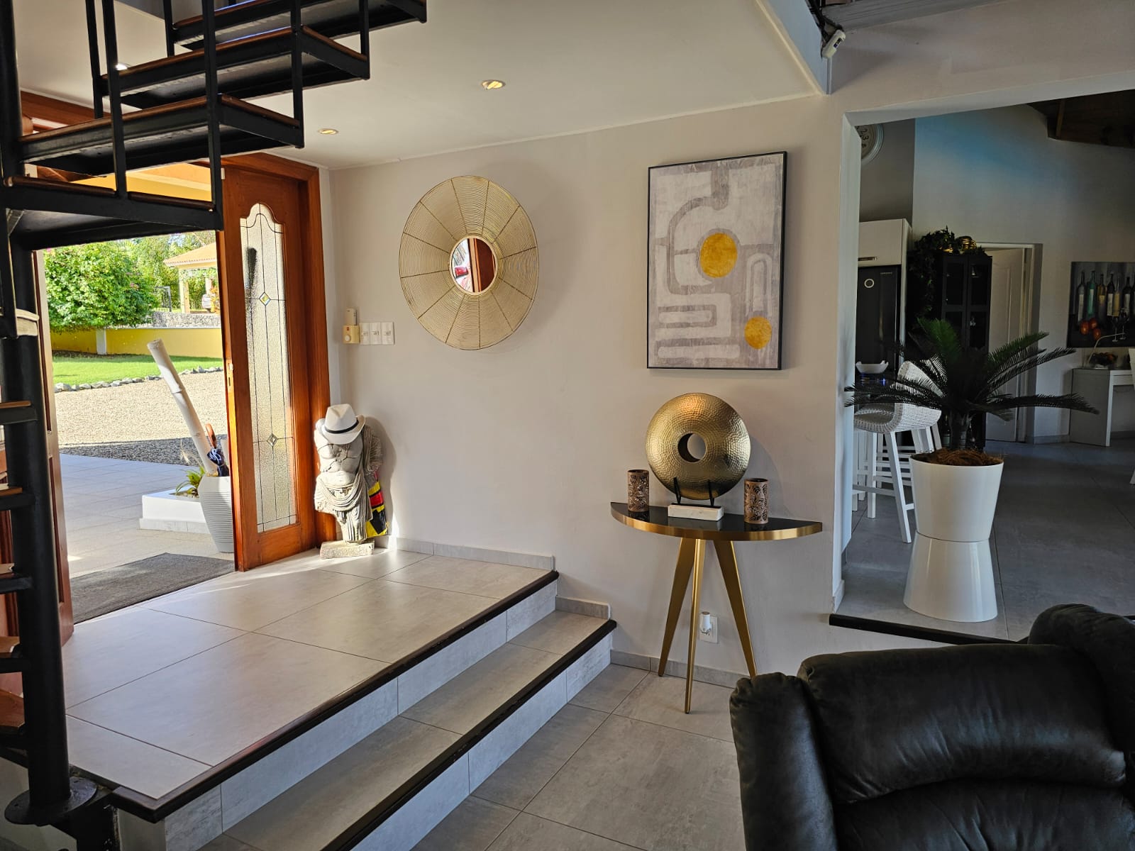 buyDRproperty Villa entrance with spiral staircase, modern decor, and open doorway leading to Ocean Views. Sosua Real Estate