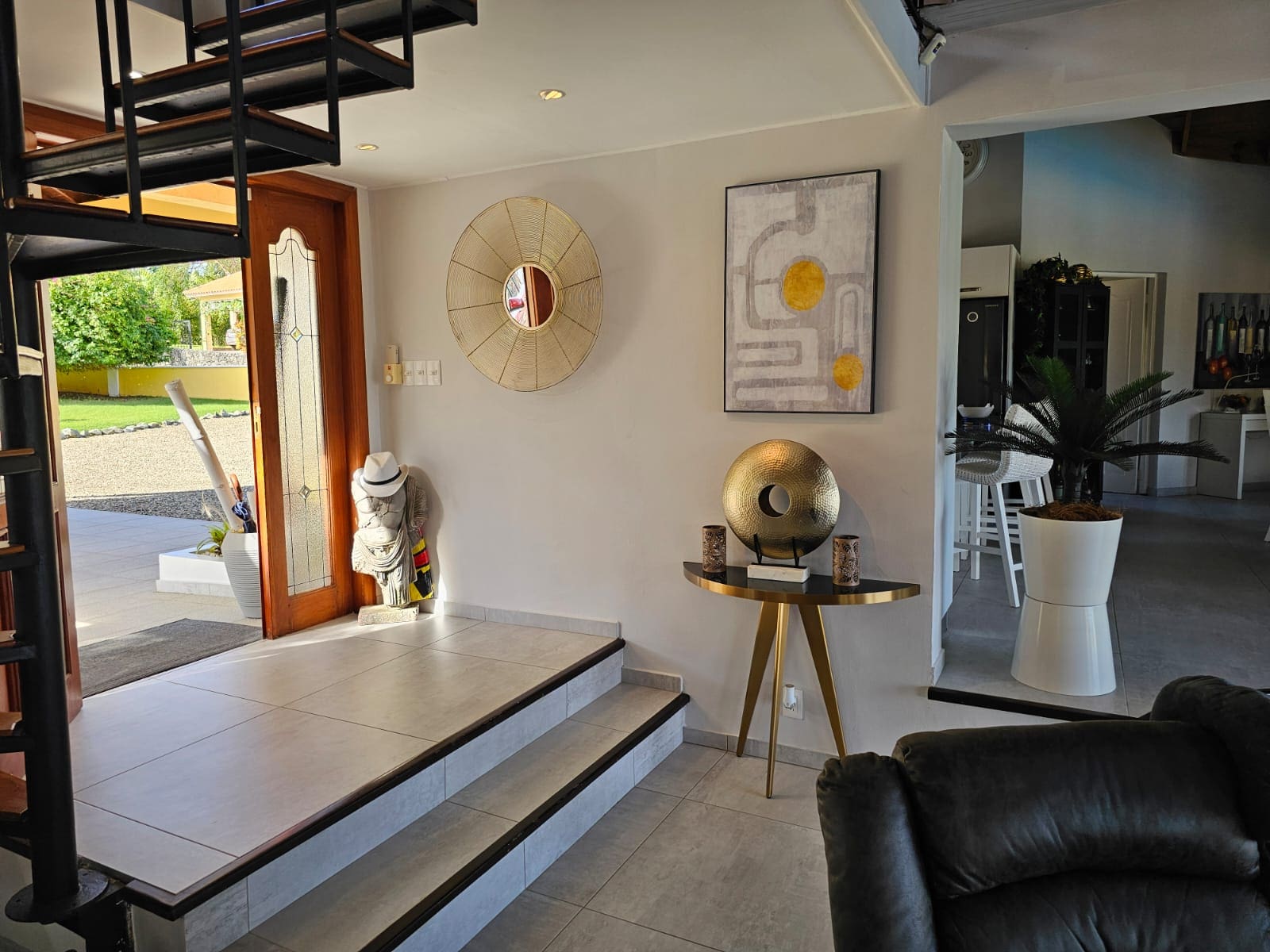 buyDRproperty Villa entrance with spiral staircase, modern decor, and open doorway leading to Ocean Views. Sosua Real Estate