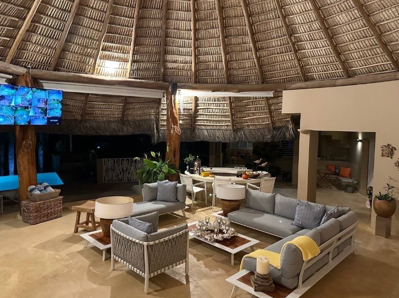 buyDRproperty Luxurious ocean view villa living room with thatched roof, for sale in the Dominican Republic. Sosua Real Estate