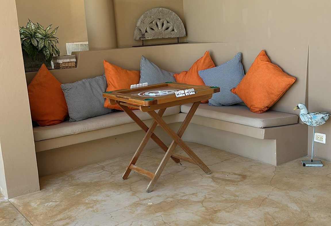 buyDRproperty Cozy seating area with orange and striped pillows in a Dominican Republic ocean view villa for sale. Sosua Real Estate