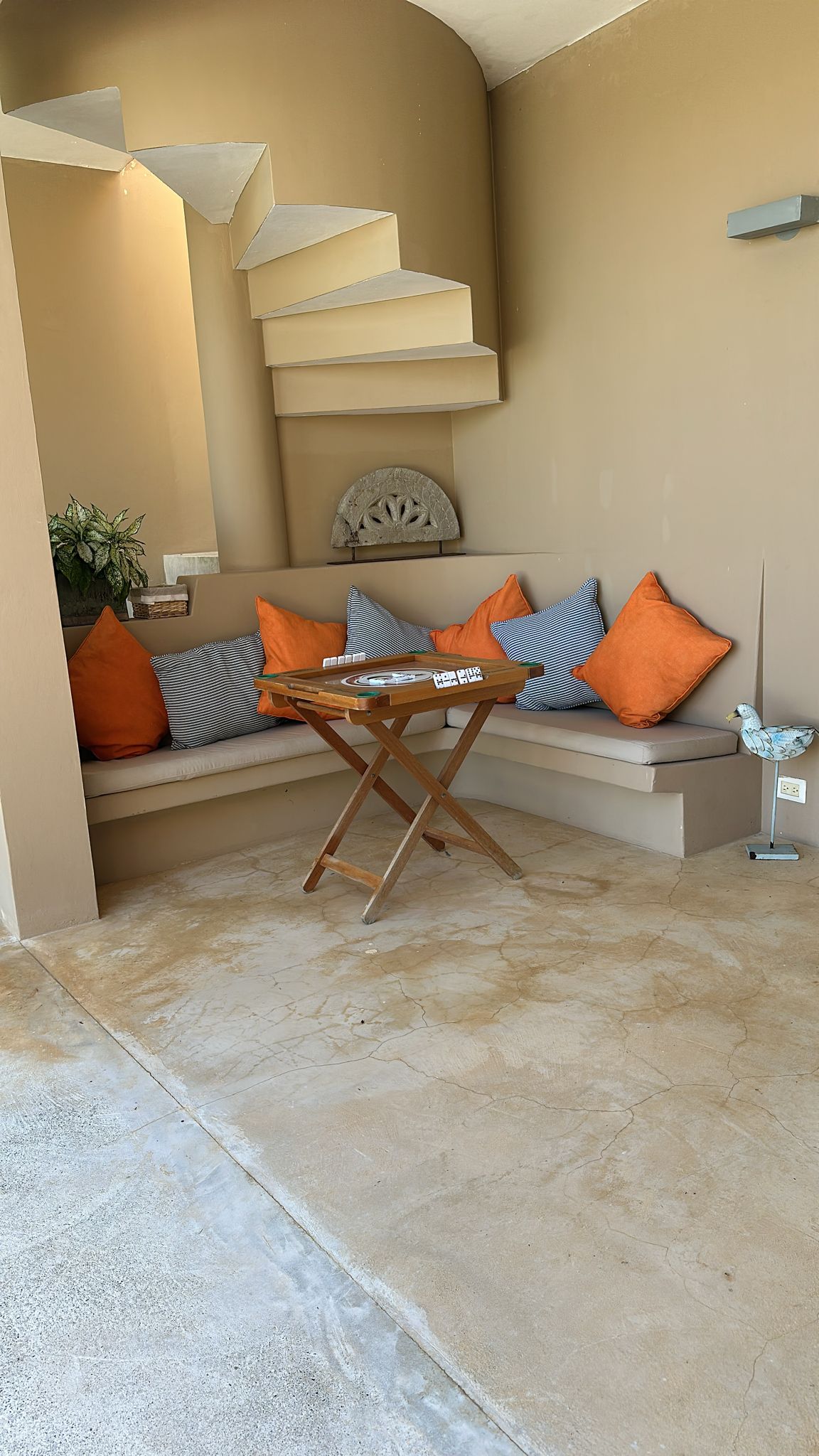 buyDRproperty Cozy seating area with orange and striped pillows in a Dominican Republic ocean view villa for sale. Sosua Real Estate