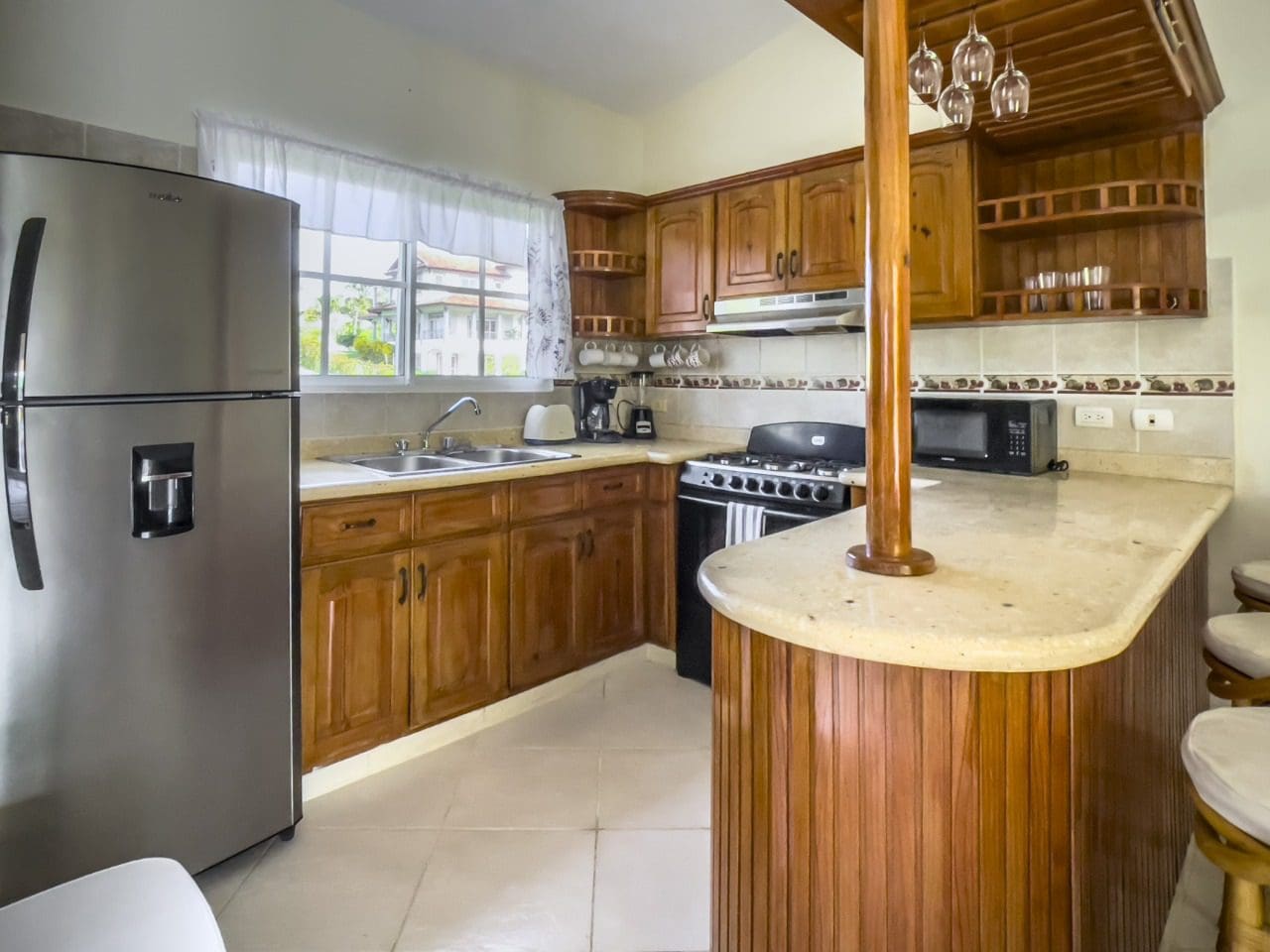buyDRproperty Kitchen interior with stainless steel refrigerator in 3BR Ocean View Home, Hispaniola Sosua Real Estate
