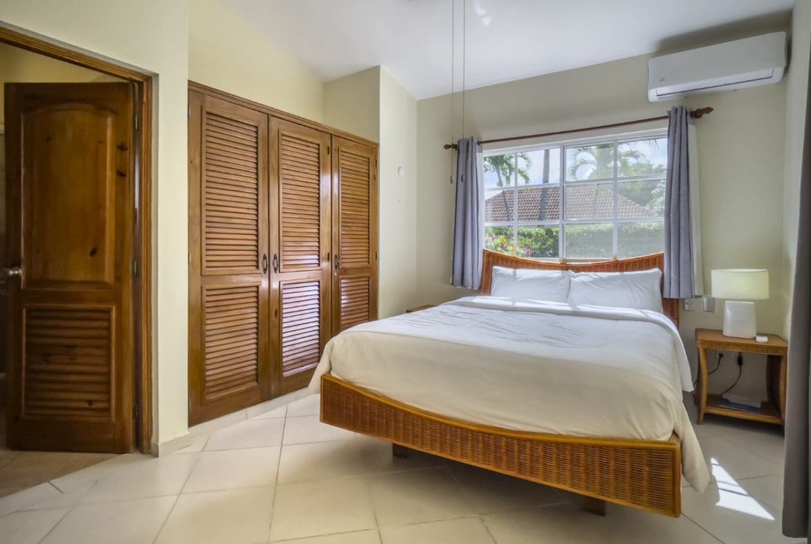 buyDRproperty Bedroom with a king-size bed, closet, and window in a 3BR Ocean View Home. Sosua Real Estate