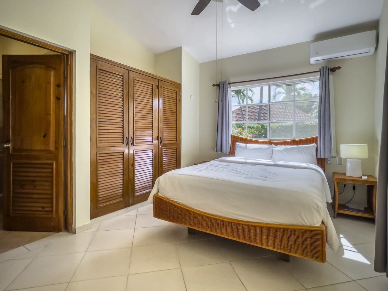 buyDRproperty Bedroom with a king-size bed, closet, and window in a 3BR Ocean View Home. Sosua Real Estate