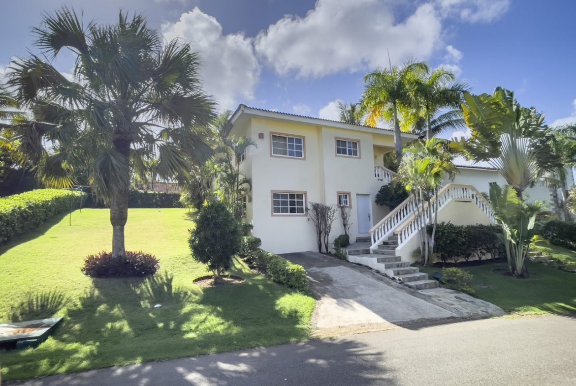 buyDRproperty 3BR Ocean View Home in Hispaniola with lush lawn and palm trees, showcasing tropical living. Sosua Real Estate