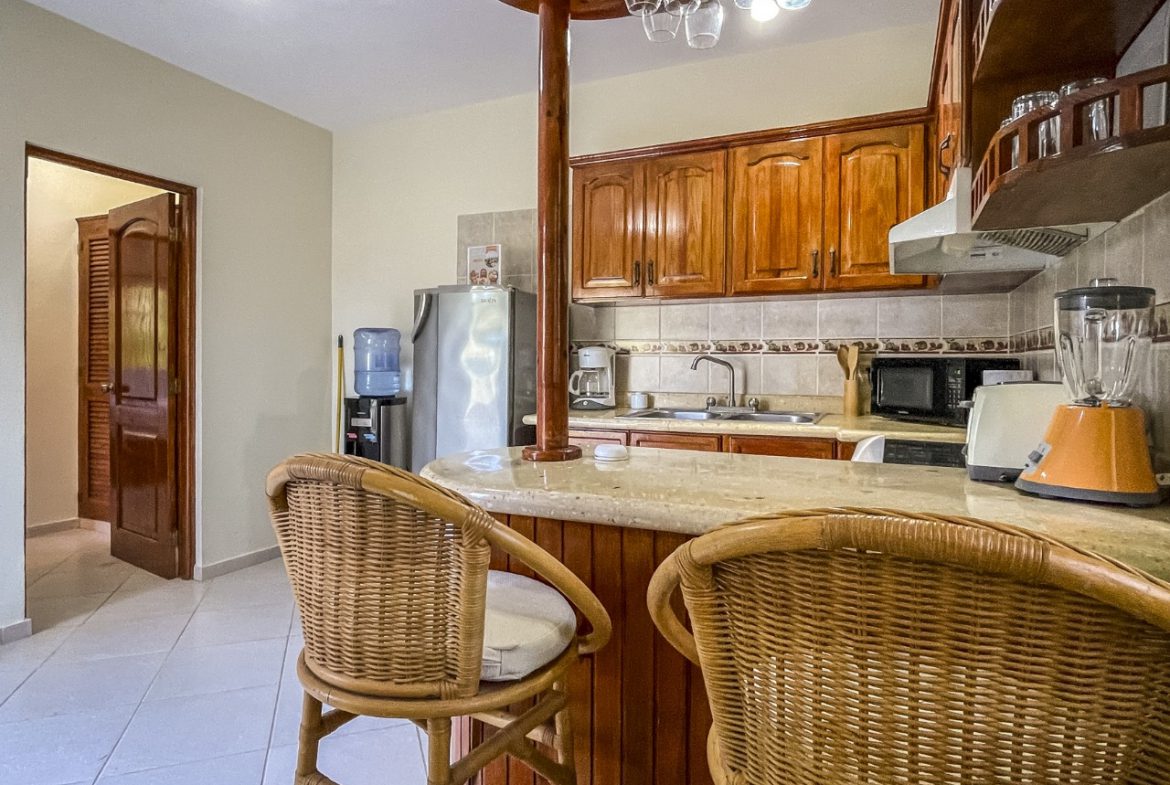 buyDRproperty Cozy kitchen with wicker bar stools in 3BR Ocean View Home for sale Sosua Real Estate