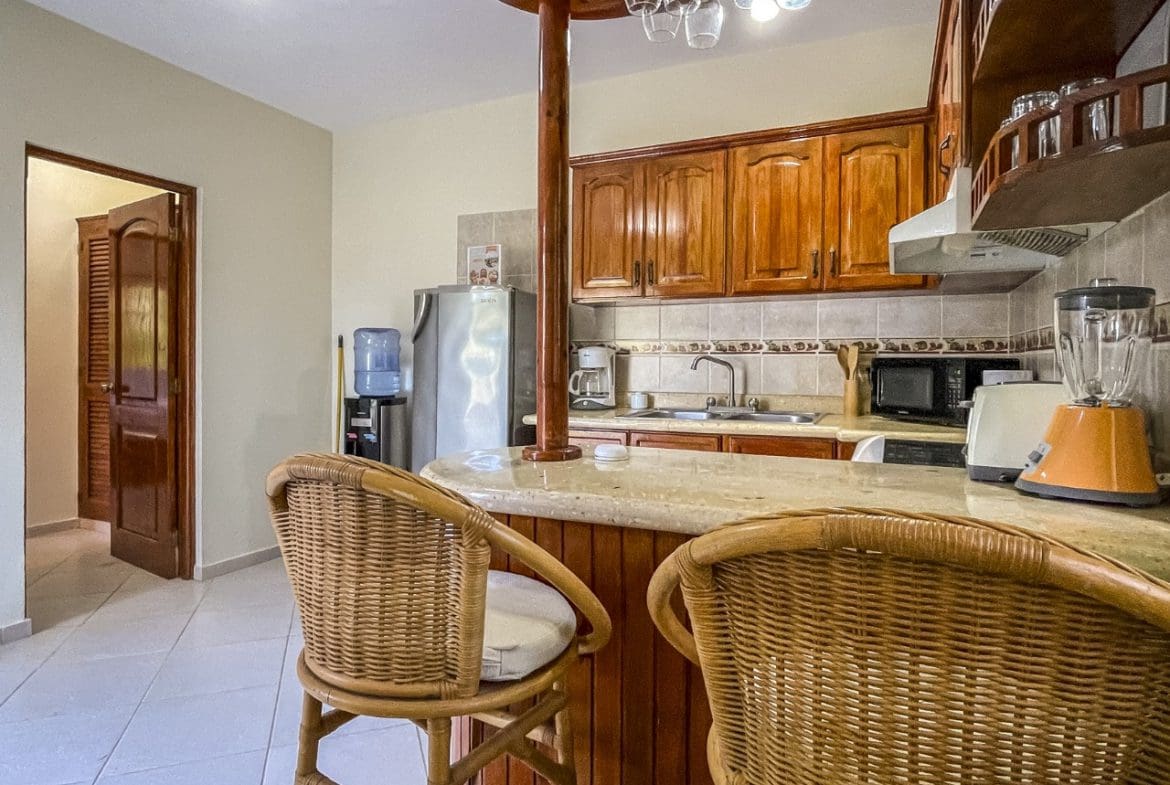 buyDRproperty Cozy kitchen with wicker bar stools in 3BR Ocean View Home for sale Sosua Real Estate