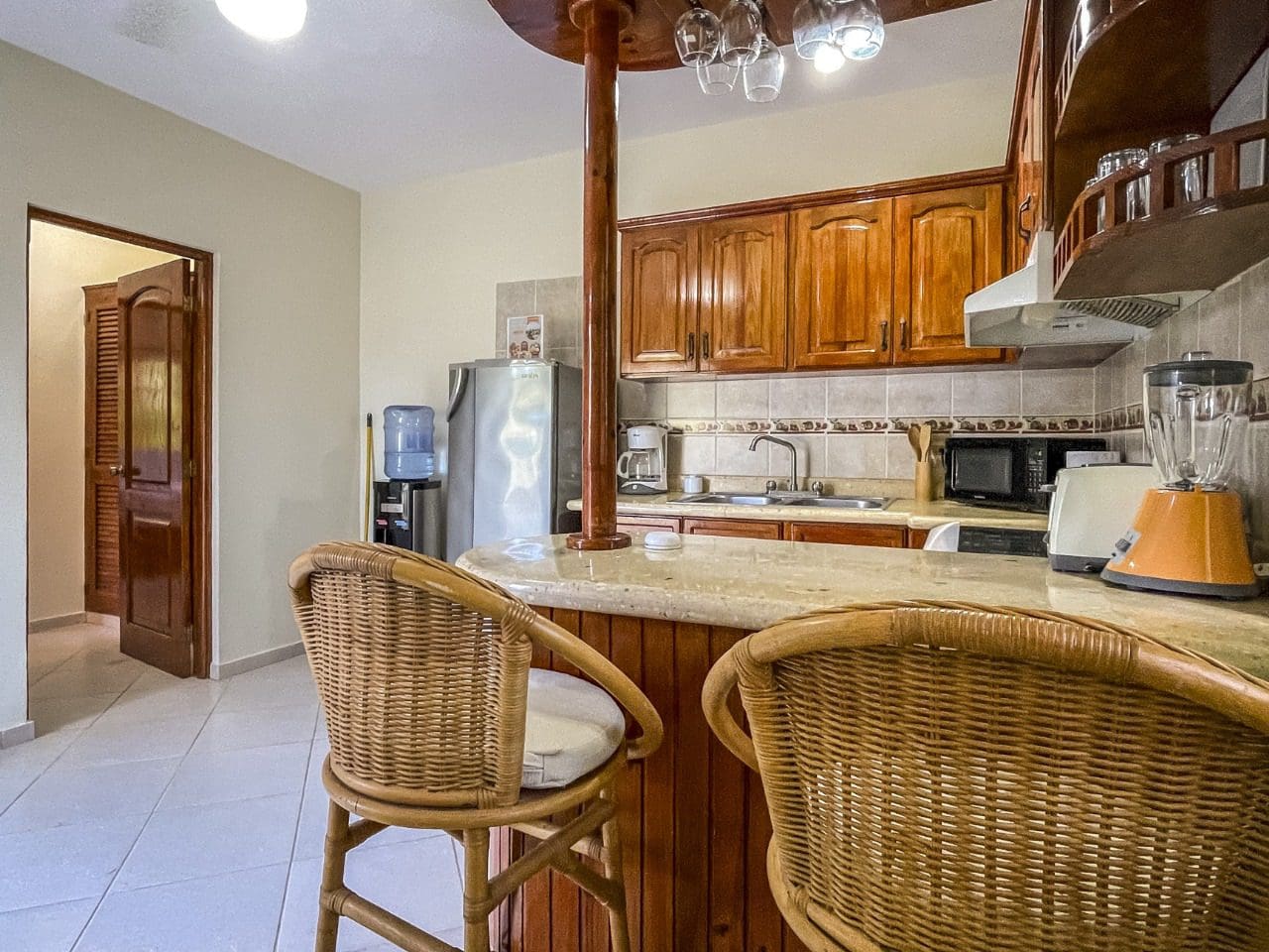 buyDRproperty Cozy kitchen with wicker bar stools in 3BR Ocean View Home for sale Sosua Real Estate