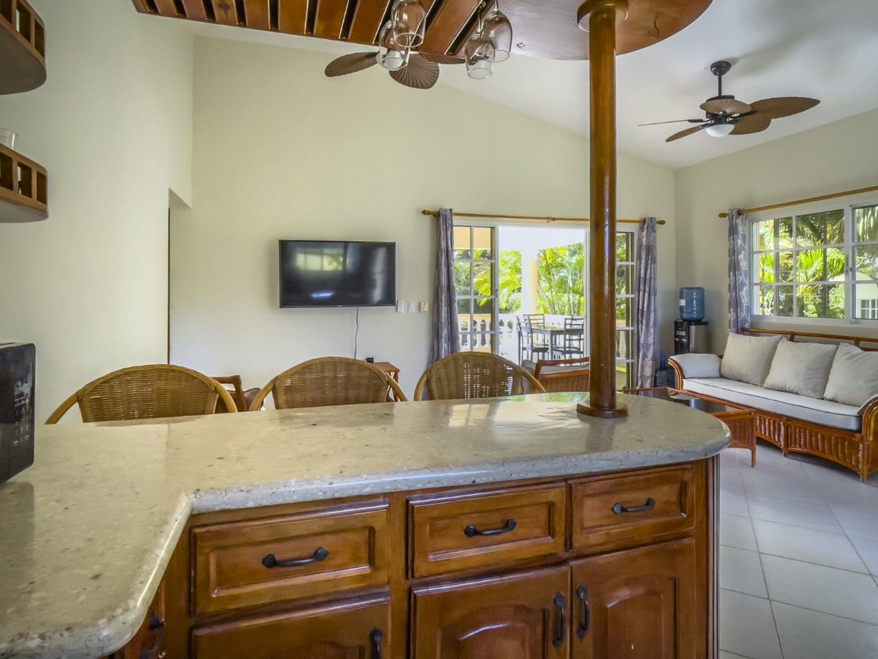 buyDRproperty Interior of a 3BR Ocean View Home, Hispaniola, with bar and living area. Sosua Real Estate