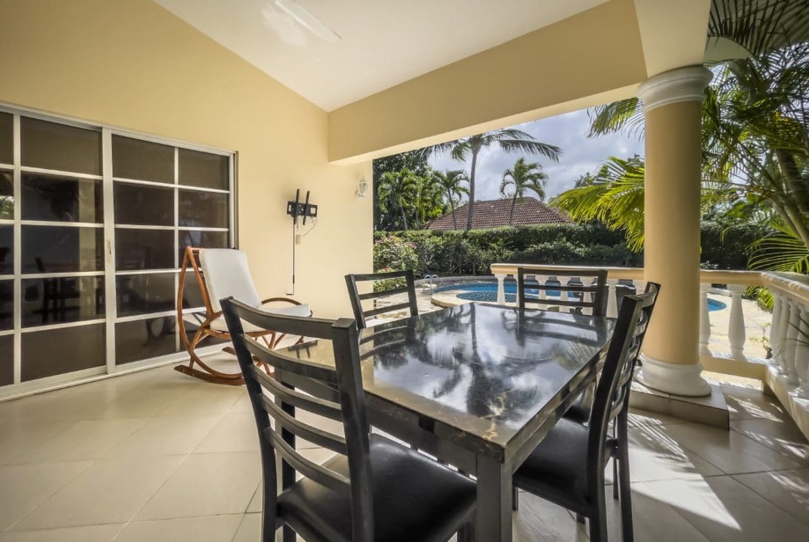 buyDRproperty Covered patio with dining table, rocking chair, and view of pool. 3BR Ocean View Home, Hispaniola. Sosua Real Estate