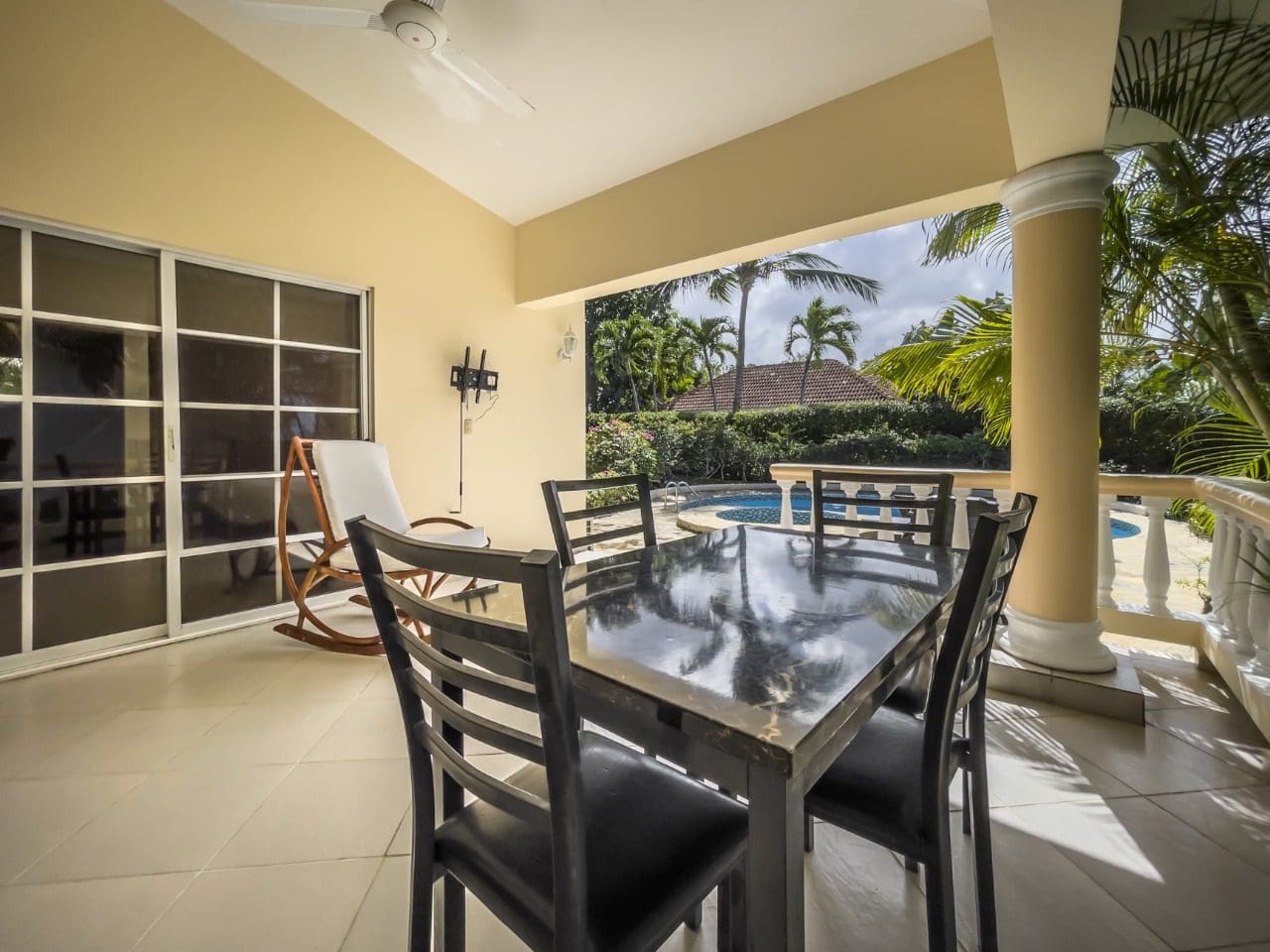 buyDRproperty Covered patio with dining table, rocking chair, and view of pool. 3BR Ocean View Home, Hispaniola. Sosua Real Estate