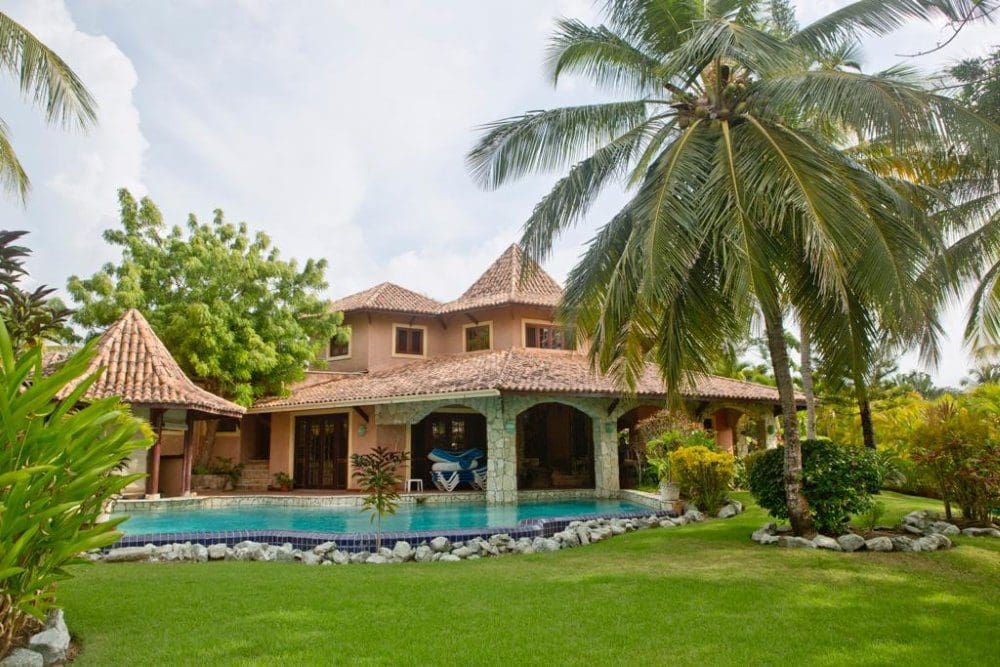 buyDRproperty Villa Estrella del Caribe with a pool and lush tropical landscaping. Sosua Real Estate
