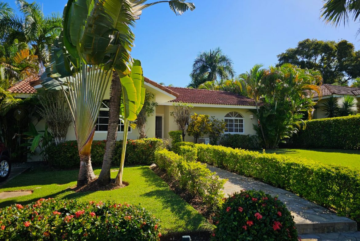 buyDRproperty Beautiful 3 Bedroom Villa For Sale with lush landscaping and a stone pathway. Sosua Real Estate