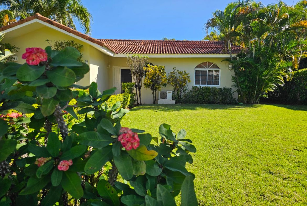 buyDRproperty 3 Bedroom Villa For Sale with lush green lawn and tropical landscaping. Sosua Real Estate
