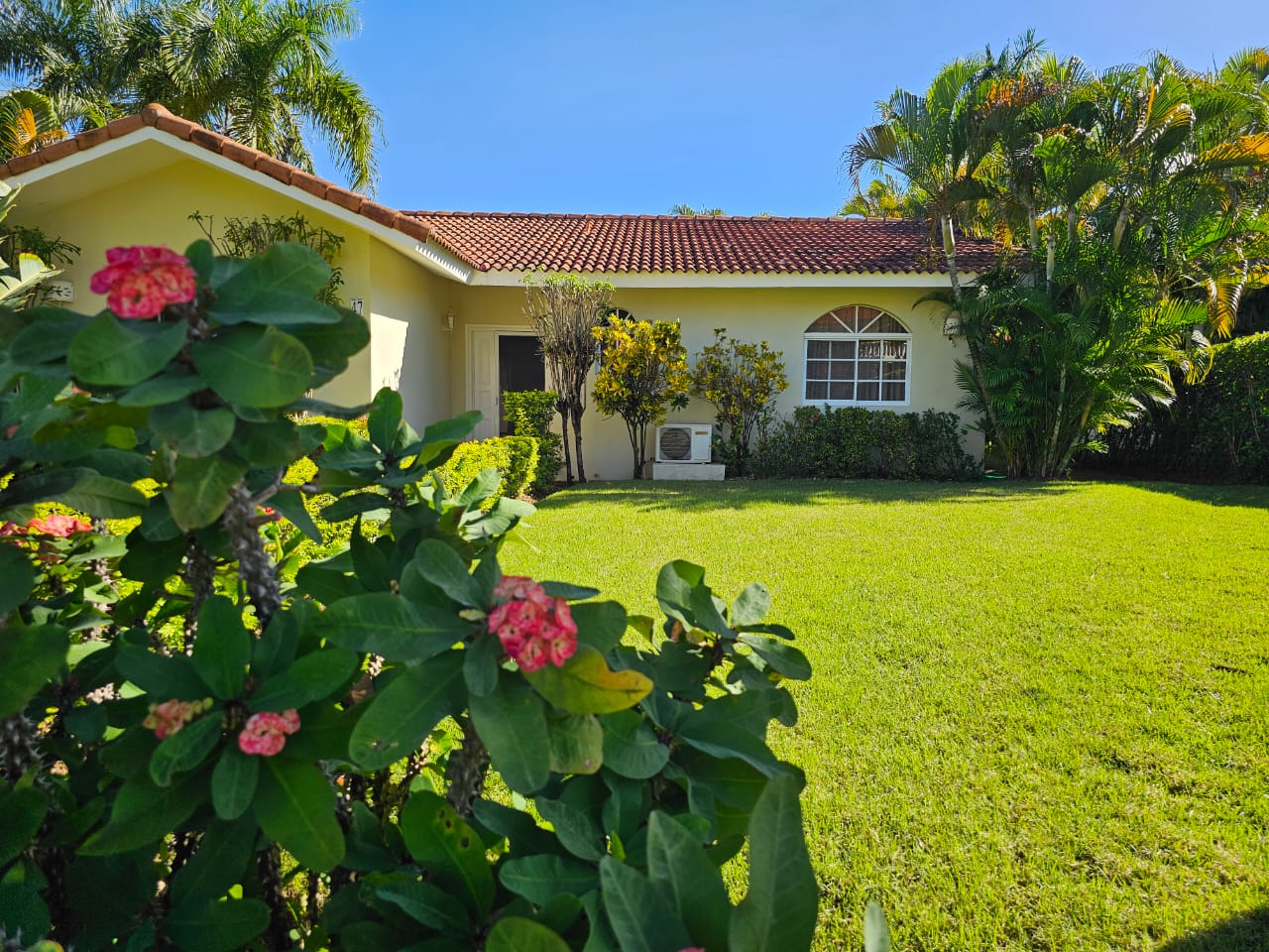 buyDRproperty 3 Bedroom Villa For Sale with lush green lawn and tropical landscaping. Sosua Real Estate