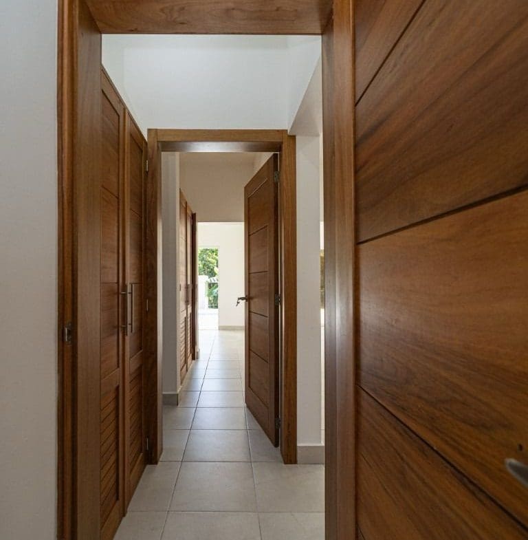 buyDRproperty Hallway with wooden doors in a home for sale. Sosua Real Estate