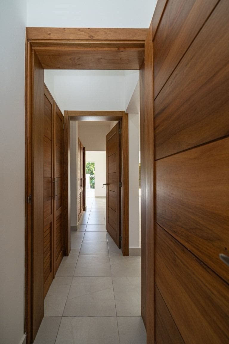 buyDRproperty Hallway with wooden doors in a home for sale. Sosua Real Estate