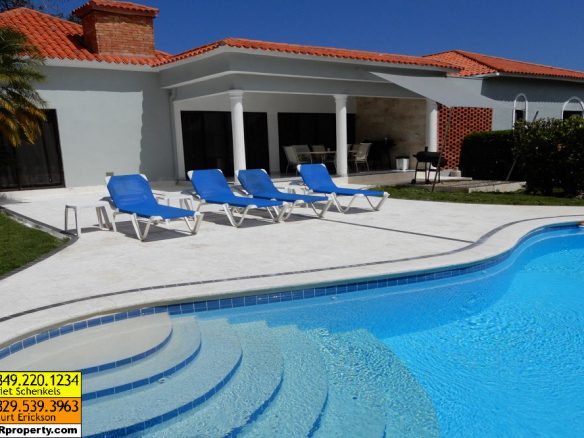 buyDRproperty Luxury villa with pool, lounge chairs, and vacation rental in the Caribbean Sosua Real Estate