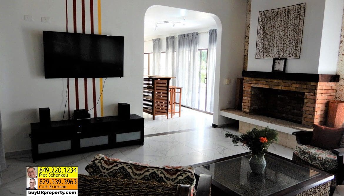 buyDRproperty Living room of a Casa Linda villa with fireplace and TV Sosua Real Estate