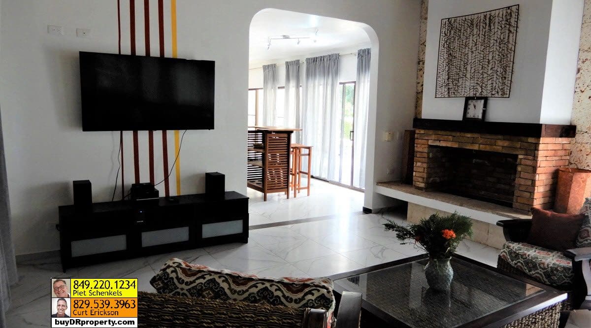 buyDRproperty Living room of a Casa Linda villa with fireplace and TV Sosua Real Estate