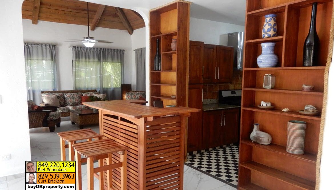 buyDRproperty Interior view of a Casa Linda villa for sale, featuring a bar and shelves. Sosua Real Estate