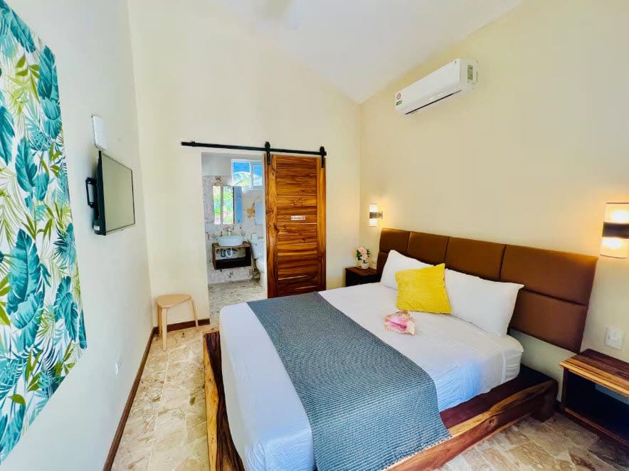 buyDRproperty Bedroom in a beautiful 9-bedroom villa with a king-size bed and ensuite bathroom. Sosua Real Estate