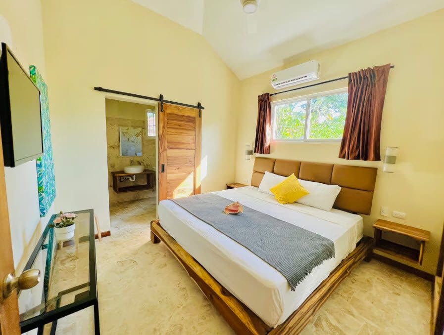 buyDRproperty Bedroom in a beautiful 9-bedroom villa with a king-size bed and ensuite bathroom. Sosua Real Estate