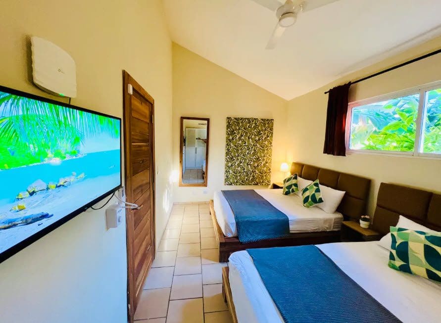 buyDRproperty Beautiful 9-Bedroom Villa room with two beds and a TV. Sosua Real Estate