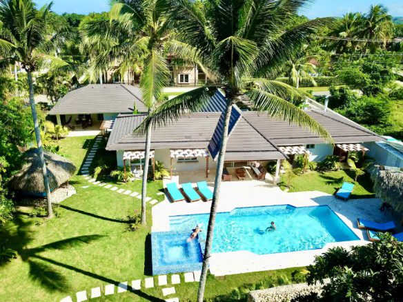 buyDRproperty Aerial view of a beautiful 9-Bedroom Villa with a pool and palm trees. Sosua Real Estate