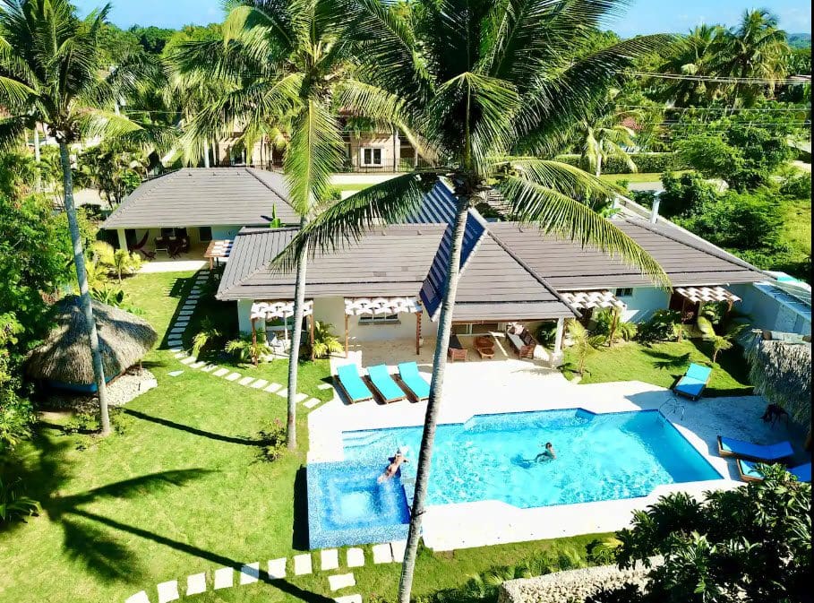 buyDRproperty Aerial view of a beautiful 9-Bedroom Villa with a pool and palm trees. Sosua Real Estate