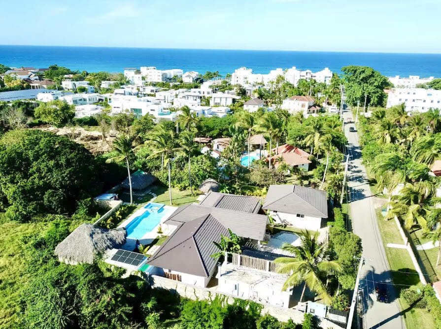 buyDRproperty Aerial view of a beautiful 9-bedroom villa with a pool, near the beach and other houses. Sosua Real Estate