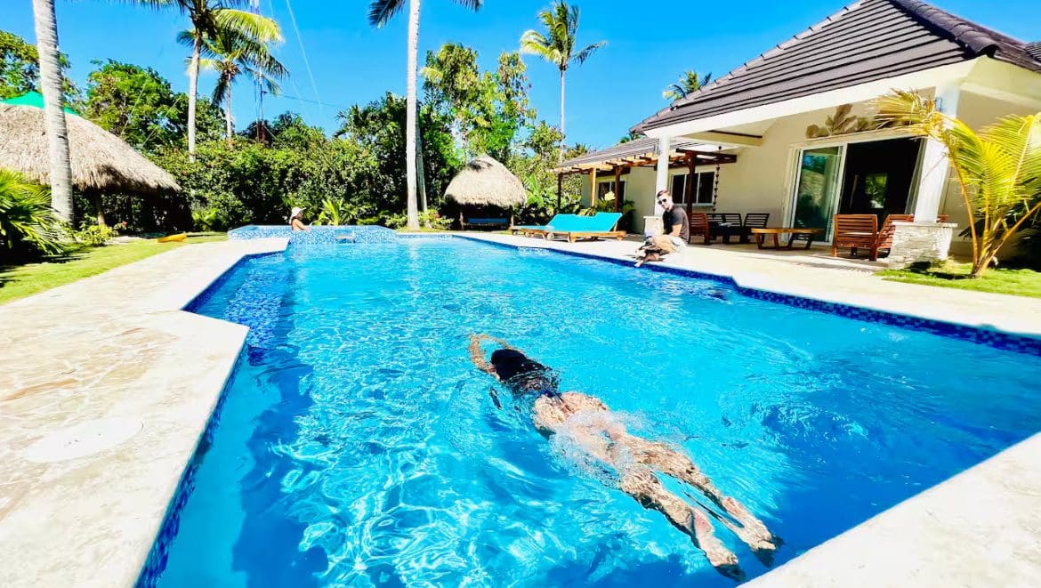 buyDRproperty Woman swimming in a pool at a beautiful 9-Bedroom Villa V5917EDJK. Sosua Real Estate