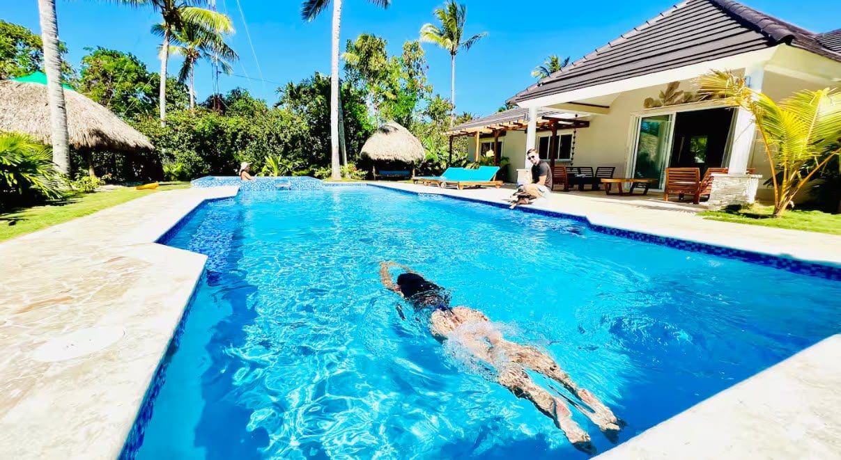 buyDRproperty Woman swimming in a pool at a beautiful 9-Bedroom Villa V5917EDJK. Sosua Real Estate