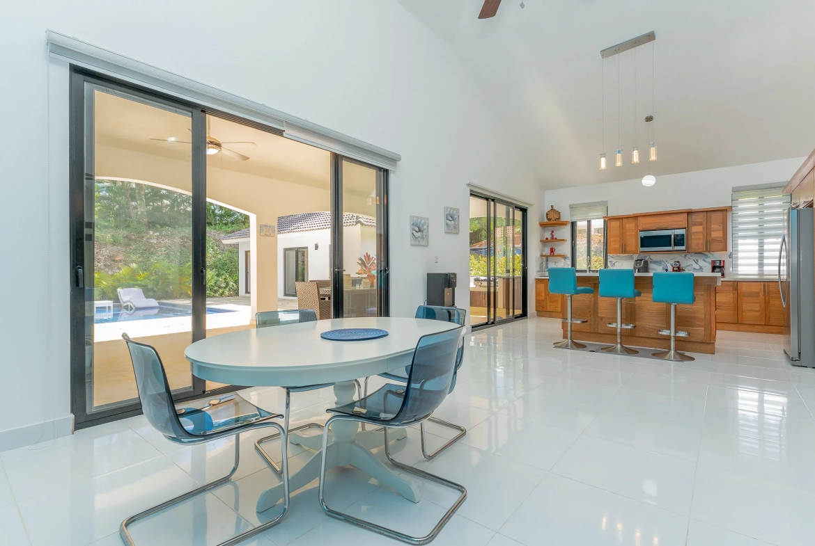buyDRproperty Dining area with white table and transparent chairs, part of the Stunning 4 Bedroom Villa In Hispaniola Residential Sosua Real Estate
