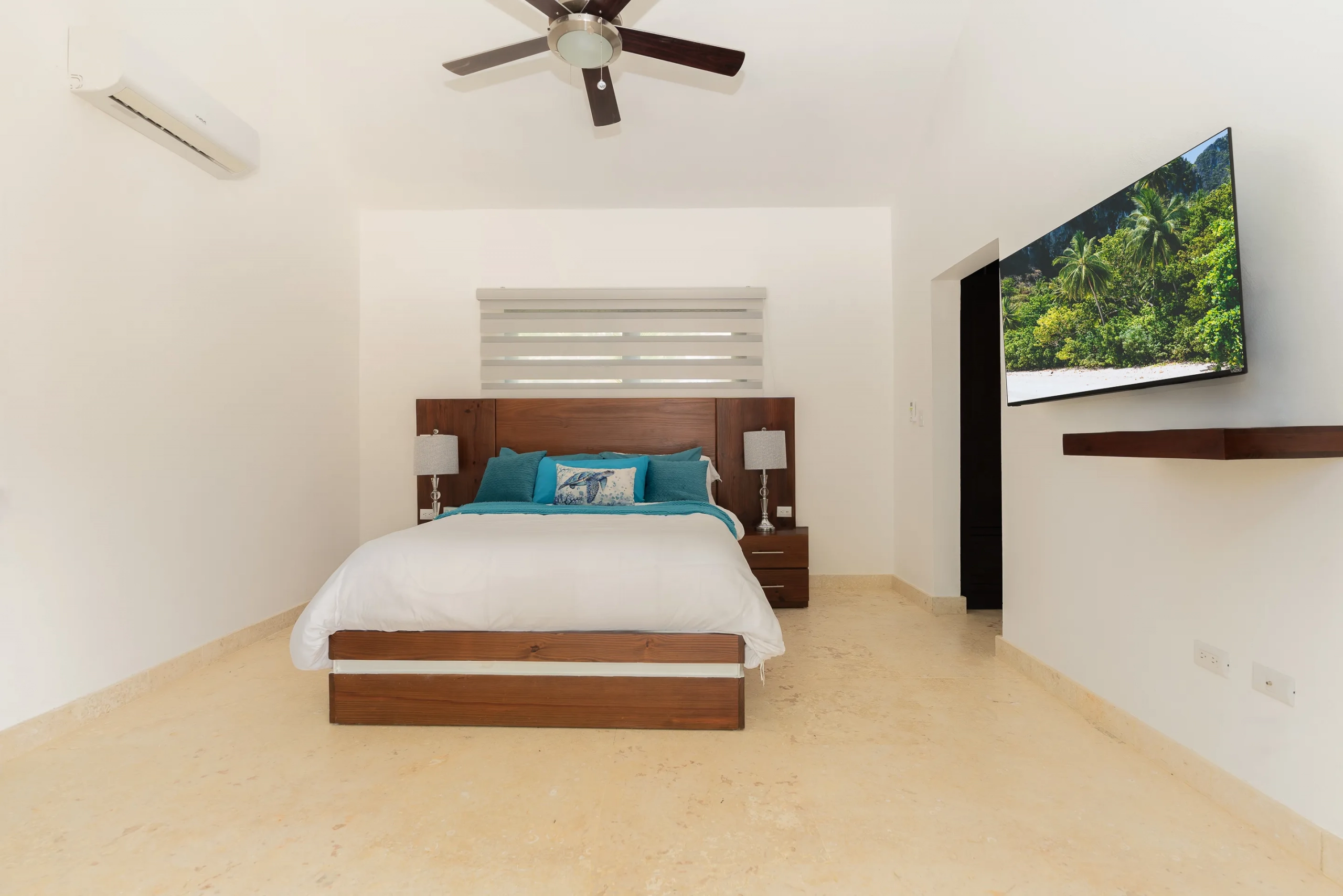 buyDRproperty Modern bedroom in a villa, with a bed, TV, and ceiling fan. Sosua Real Estate