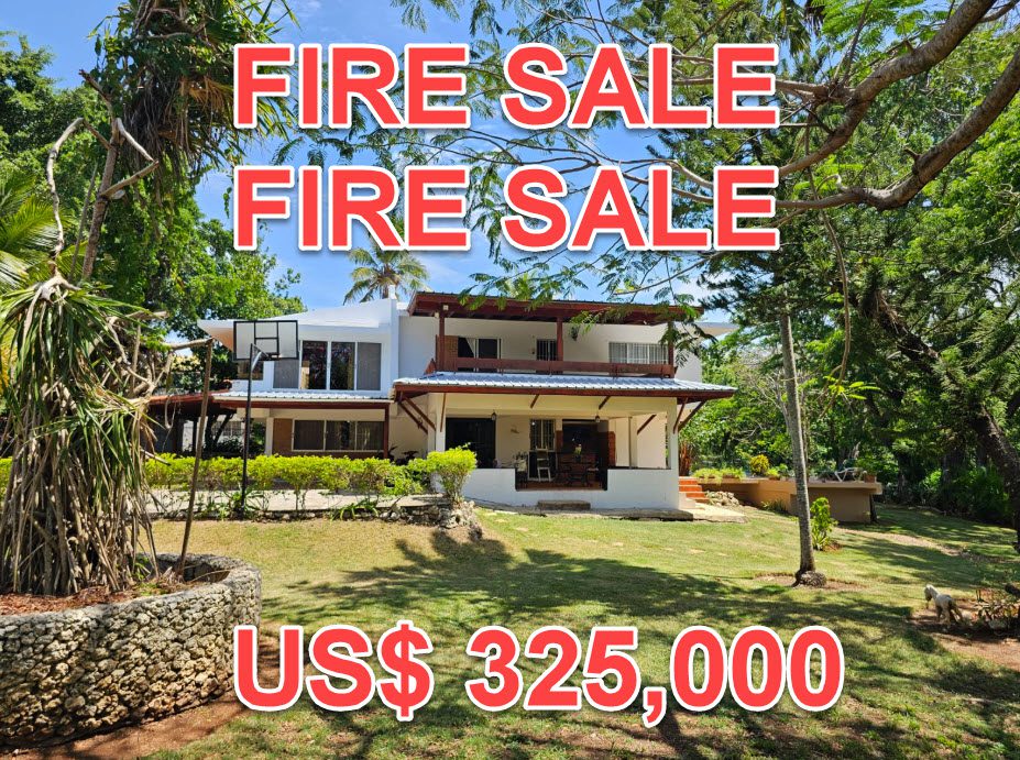 buyDRproperty Unique 4BR villa in Sosúa with "FIRE SALE" text overlay and US$325,000 price. Lush greenery surrounds the property. Sosua Real Estate