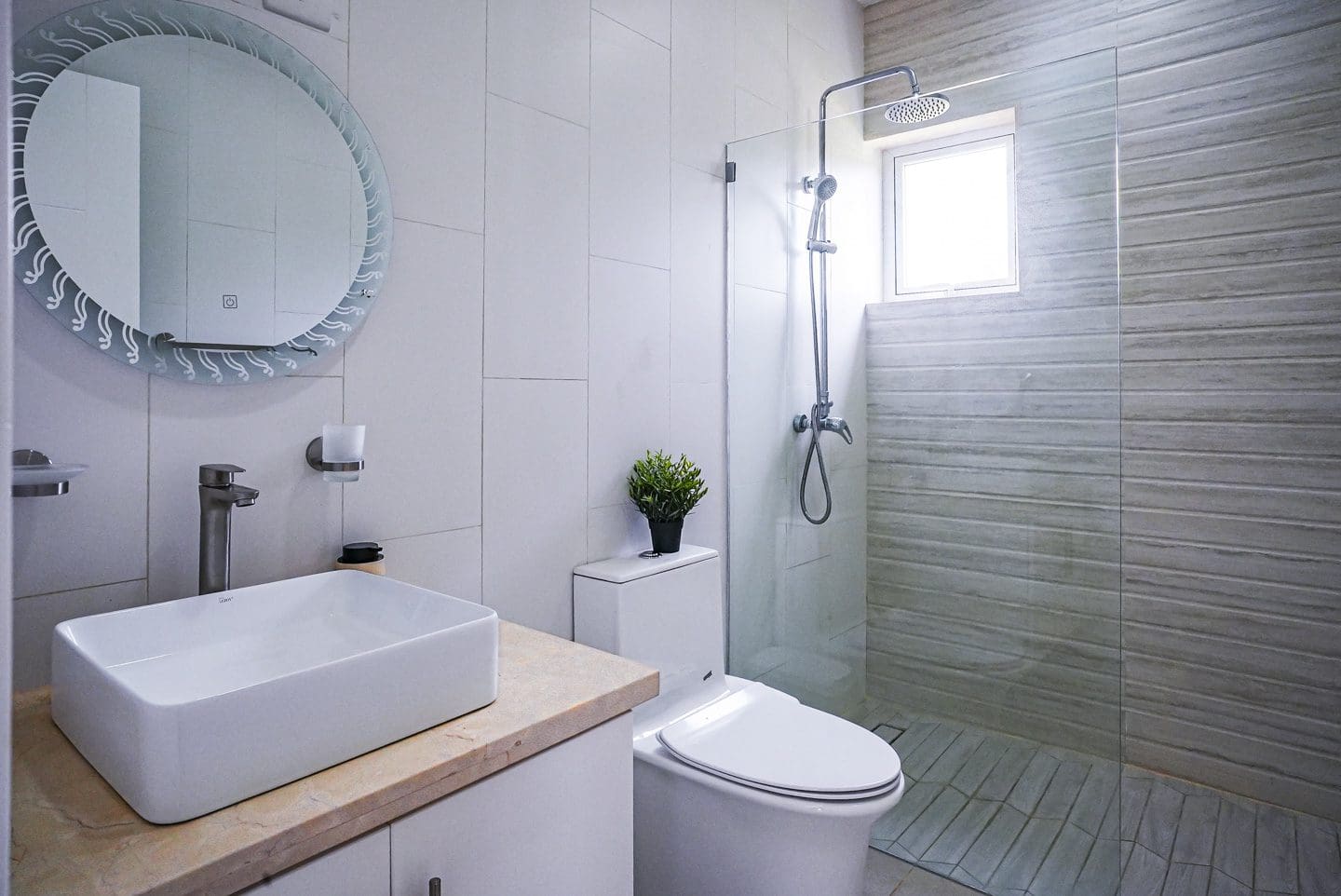 buyDRproperty Modern bathroom in a villa with a glass shower and white fixtures. Sosua Real Estate