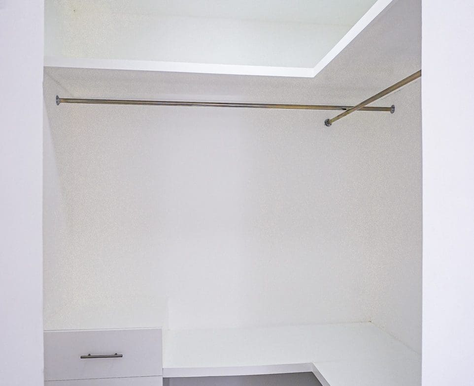 buyDRproperty Modern white closet with drawers and hanging rods in a villa. Sosua Real Estate