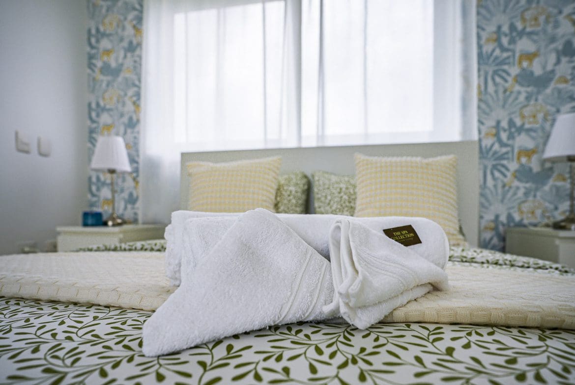 buyDRproperty White towels folded on a bed in a modern bedroom at Sosua Ocean Village. Sosua Real Estate