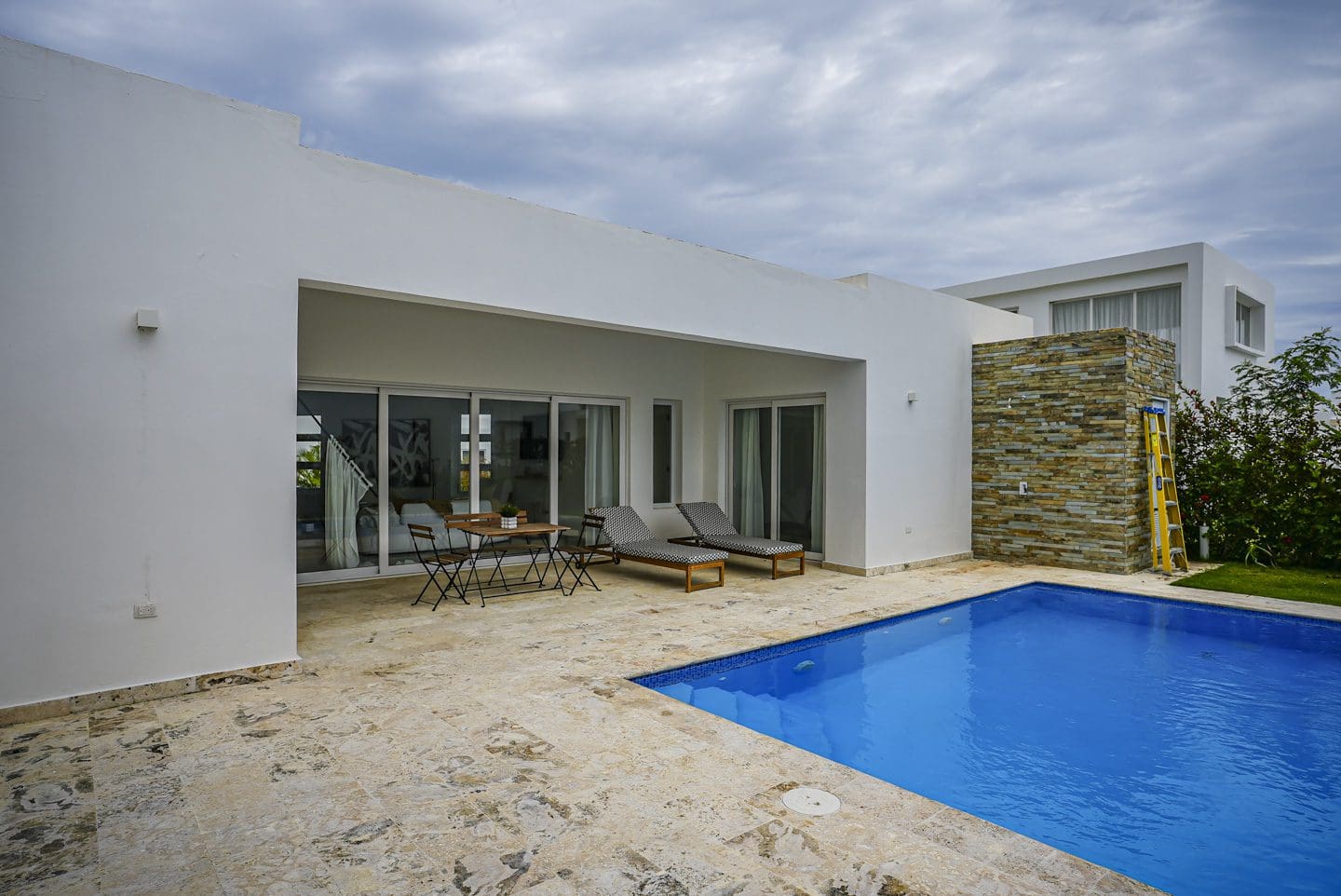 buyDRproperty Modern villa with a pool and patio furniture. Sosua Real Estate