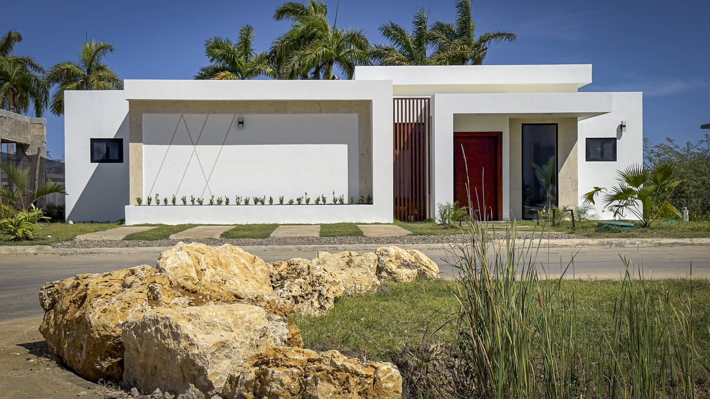 buyDRproperty Modern white luxury villa with private pool and tropical landscaping in Sosua Ocean Village