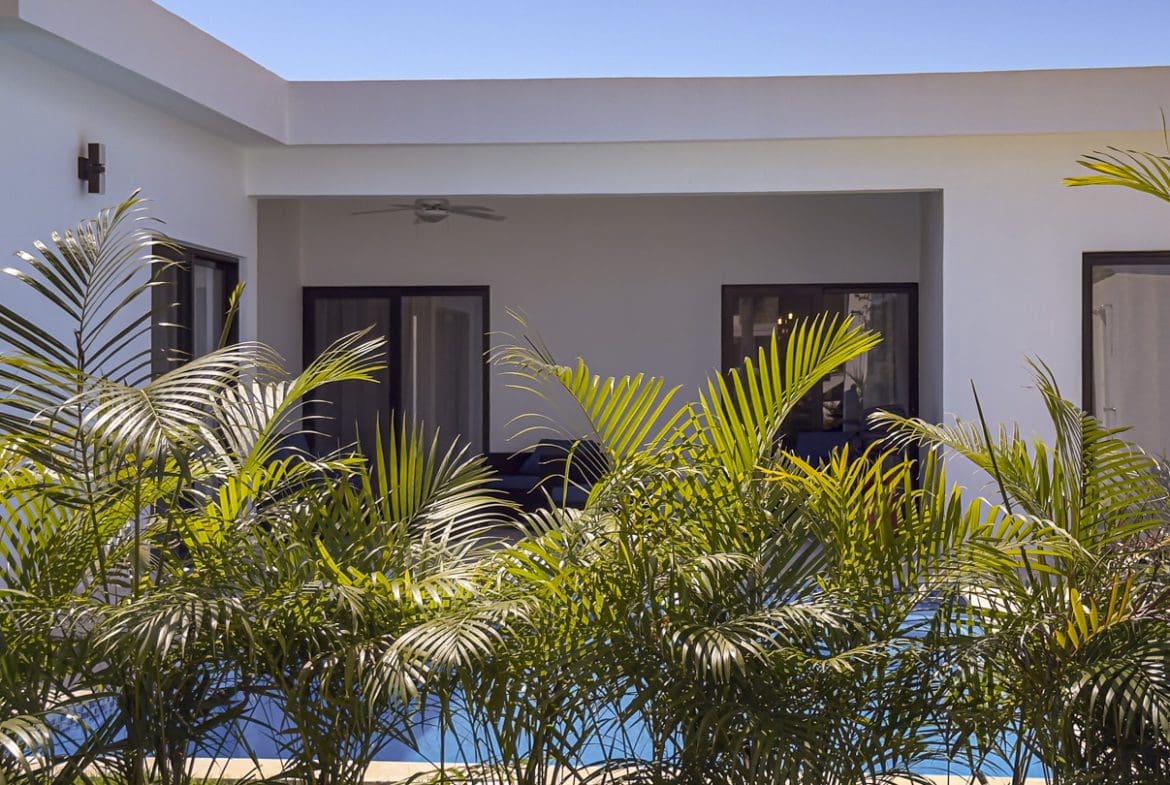 buyDRproperty Modern 3BR Villa in Sosua Ocean Village with palm trees and a pool Sosua Real Estate