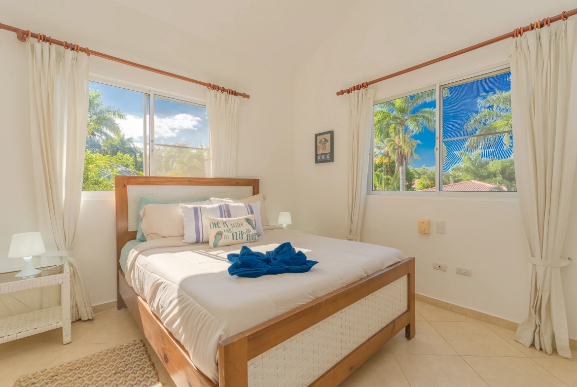 buyDRproperty Bedroom in a 3-bedroom villa with a view of palm trees. Sosua Real Estate