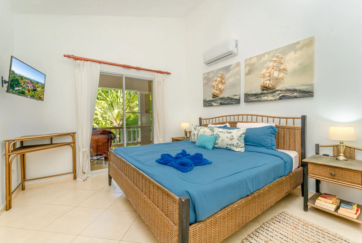 buyDRproperty Spacious bedroom with blue bedding in a Sosua 3-bedroom villa Sosua Real Estate