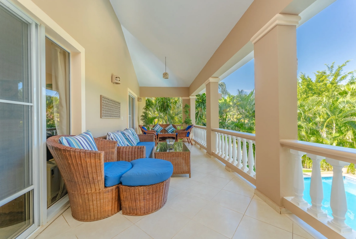 buyDRproperty Outdoor patio of a Sosua 3-bedroom villa with wicker furniture and pool view. Sosua Real Estate