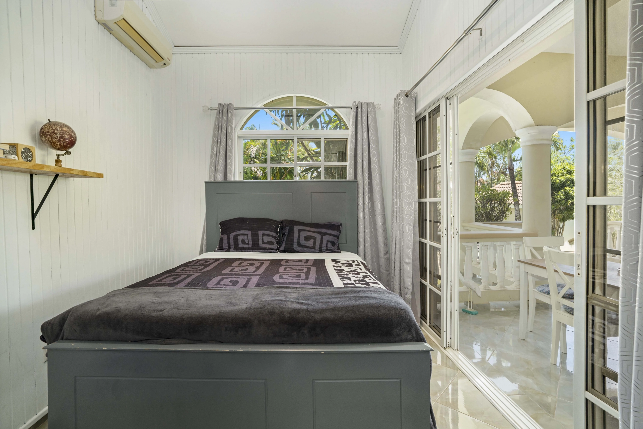 buyDRproperty Beautiful bedroom with a bed, window, and view to the outside area. Sosua Real Estate