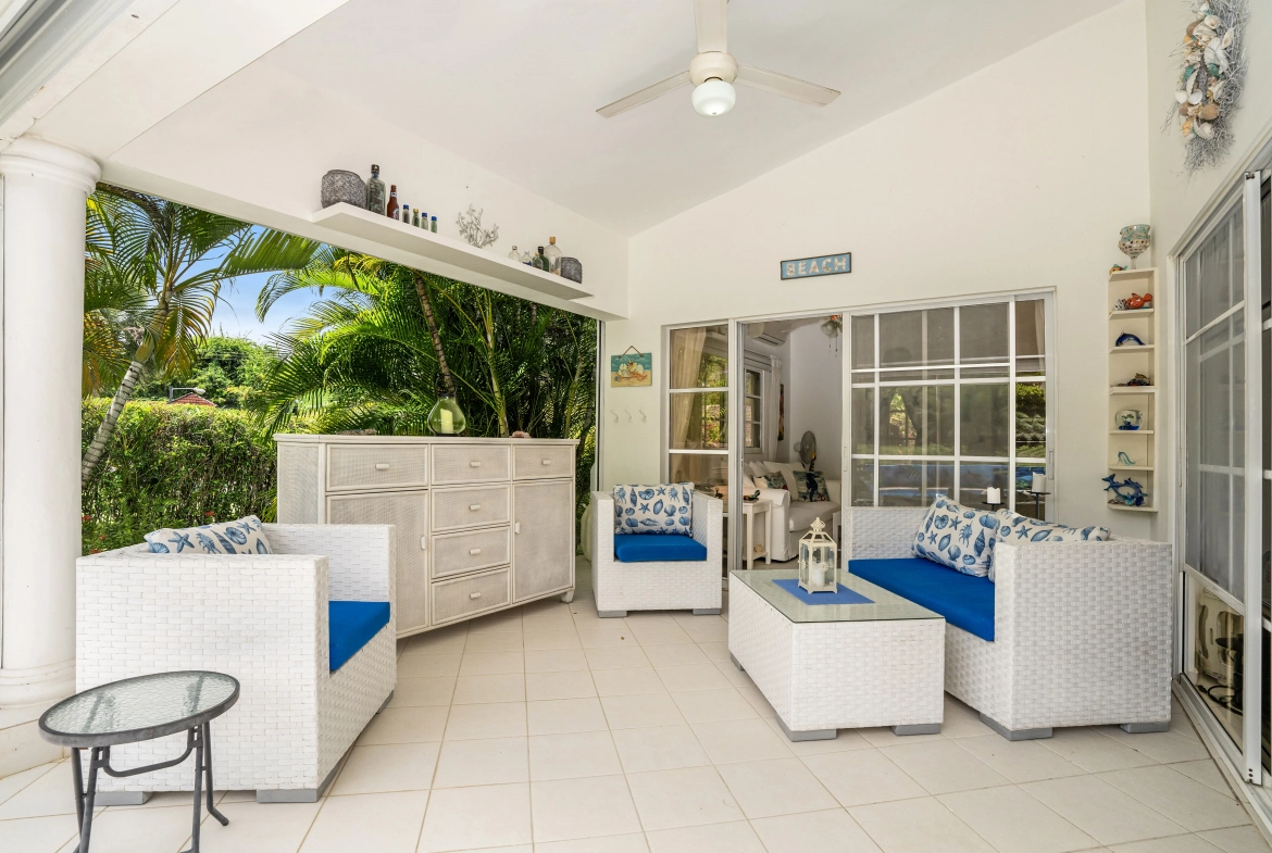 buyDRproperty Charming outdoor living space with white wicker furniture and blue cushions. Sosua Real Estate