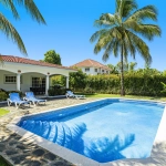 Buydrproperty Oversized Villa in Sosua with a Pool Lounge Chairs and Palm Trees Sosua Real Estate Buydrpropertycom Buydrpropertycom