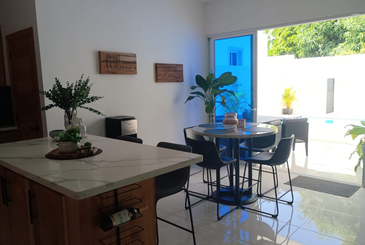 buyDRproperty Modern kitchen and dining area in a Puerto Plata villa with open plan design Sosua Real Estate